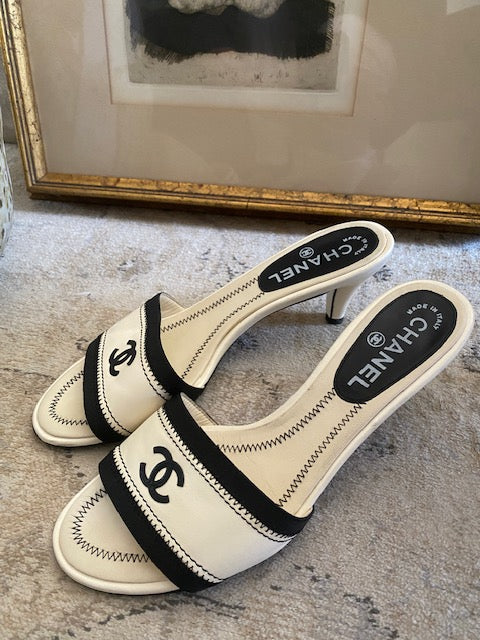 CHANEL white and black mules with signature CC.